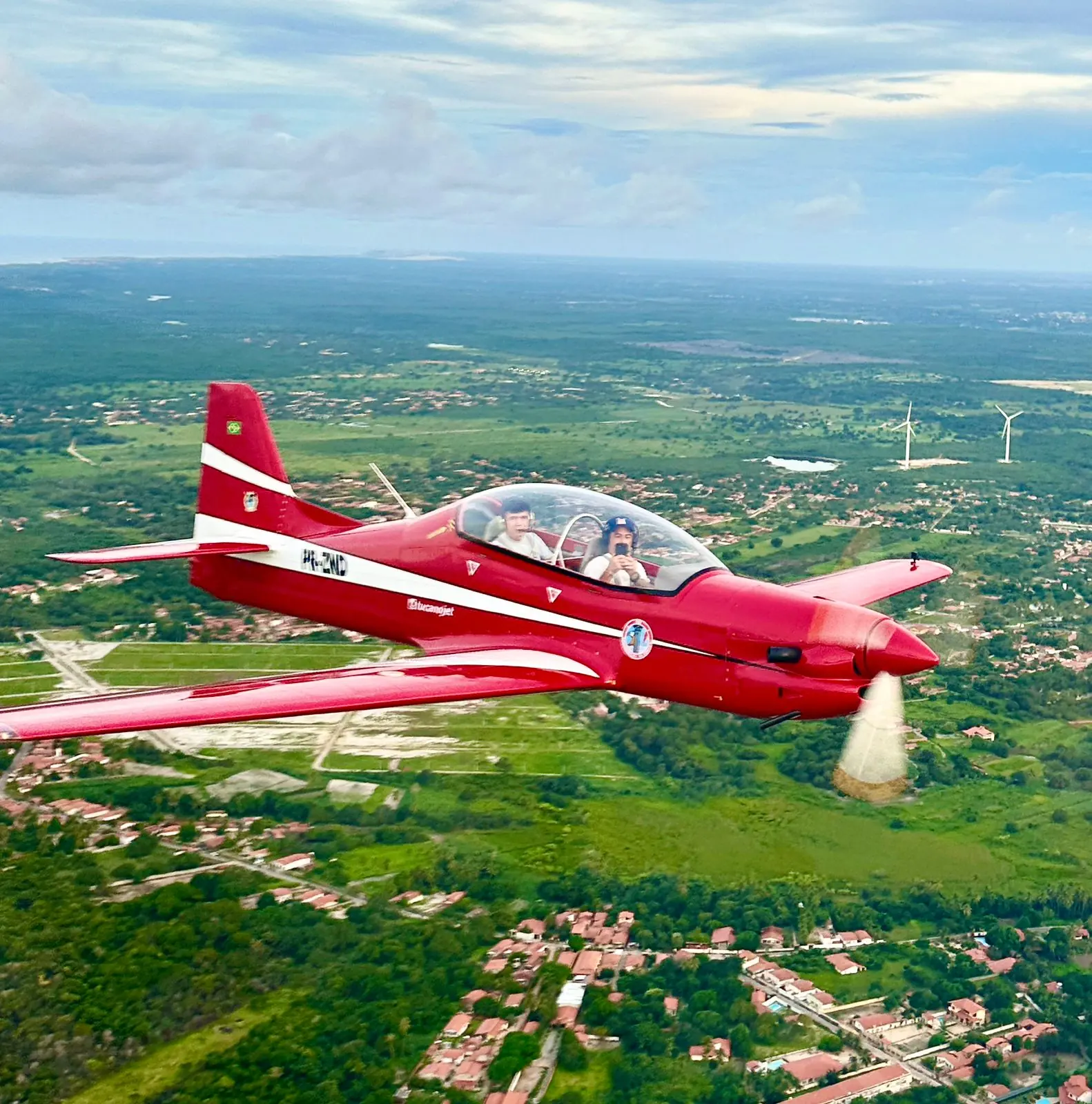 PR-ZND in flight over green countryside in Ceará