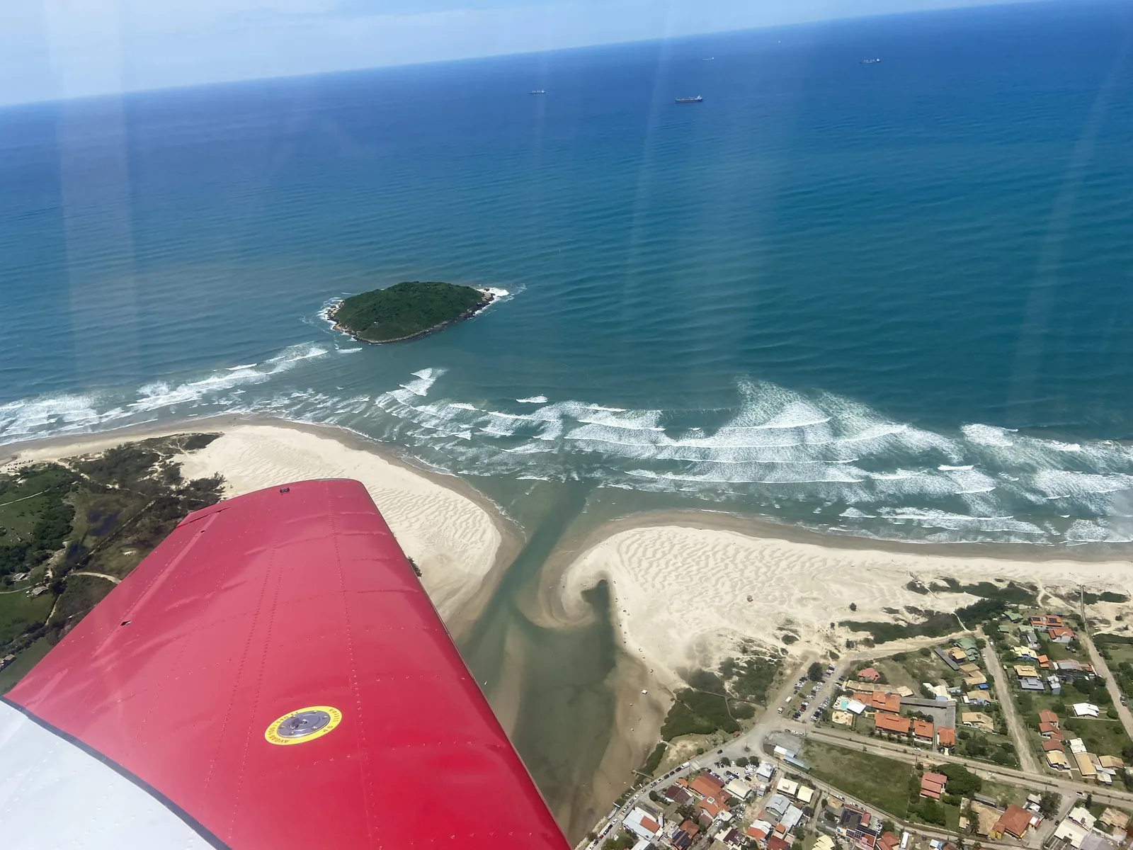 The red wing over a river mouth and beach on the coast of Santa Catarina