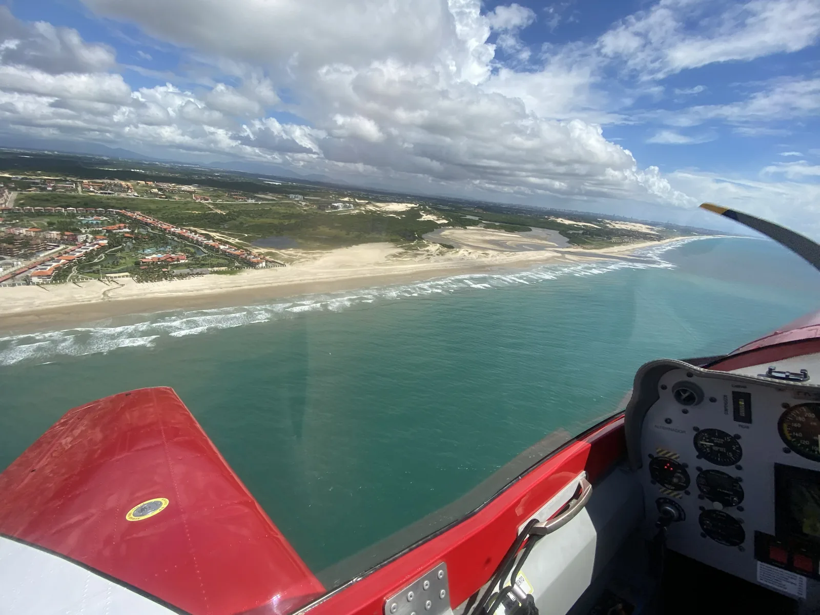 View from the cockpit over the wing and the coastline of Ceará